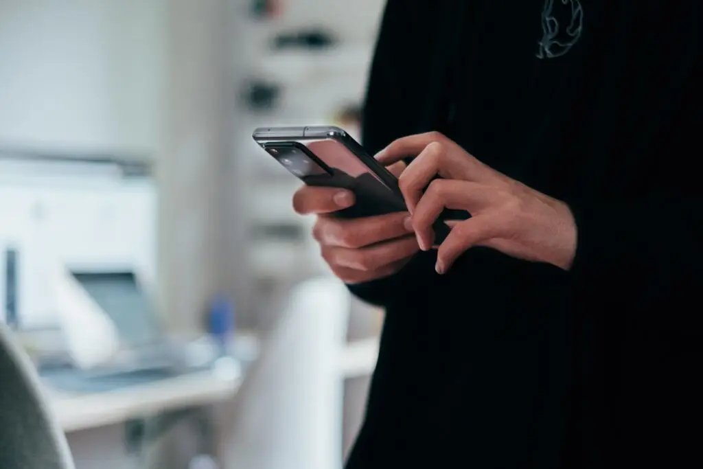 a professional marketing handling his or her smart phone