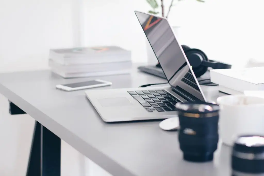desk with laptop about to close it's monitor with other office stuff