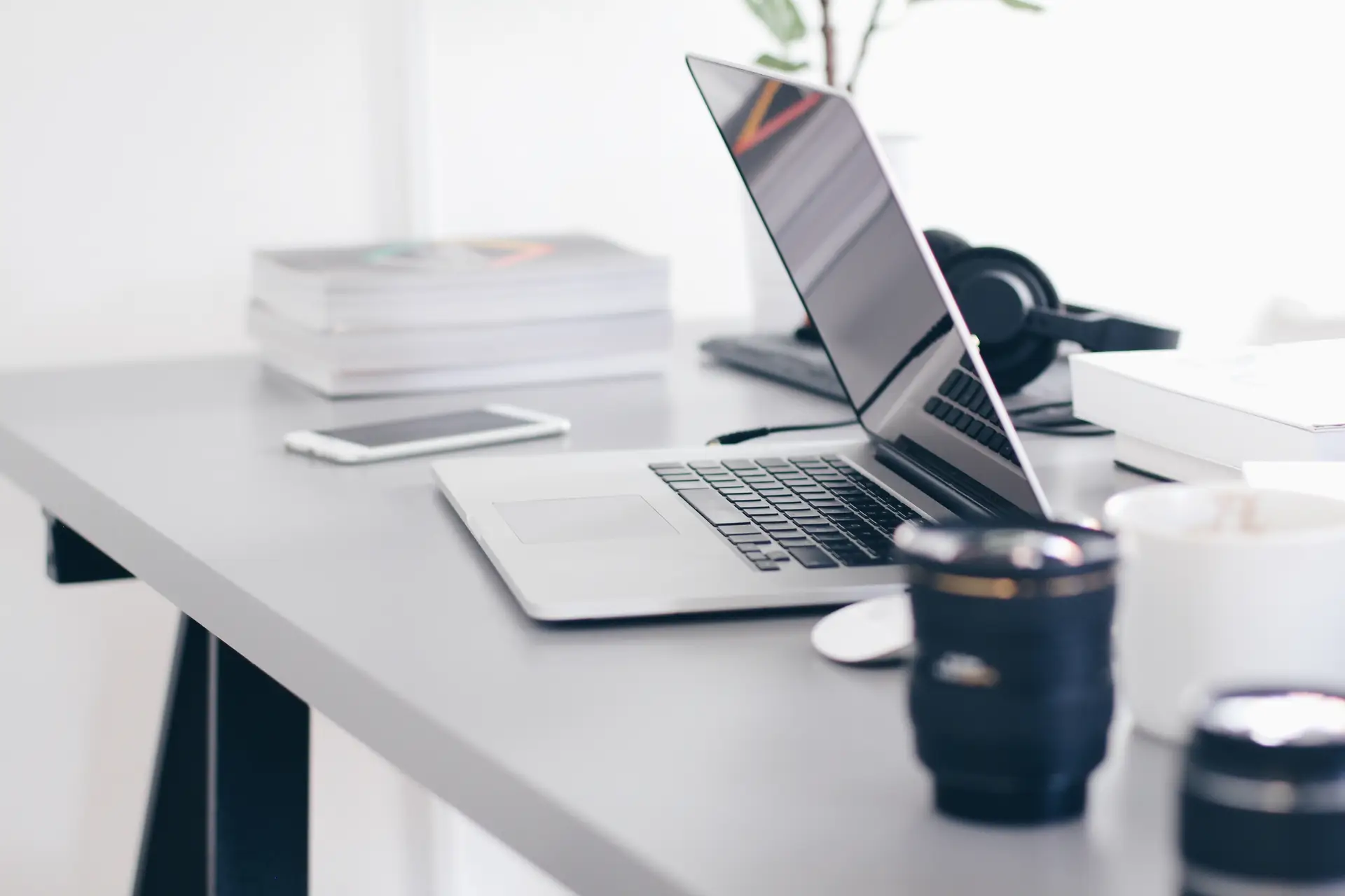 desk with laptop about to close it's monitor with other office stuff