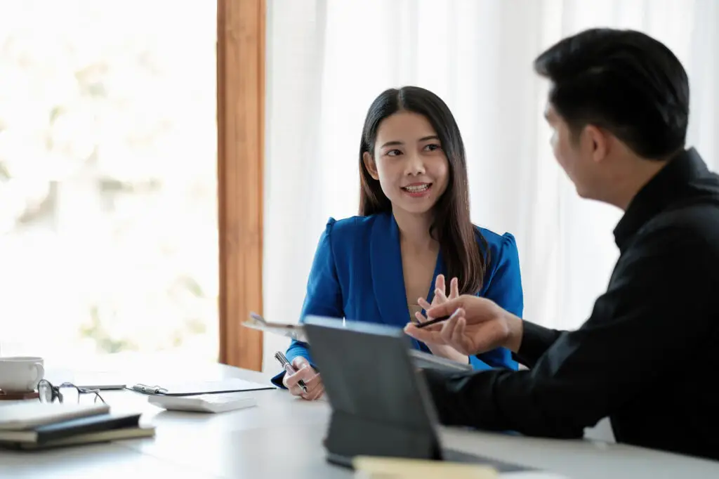 a discussion of a man and professional women in her best smile to her client