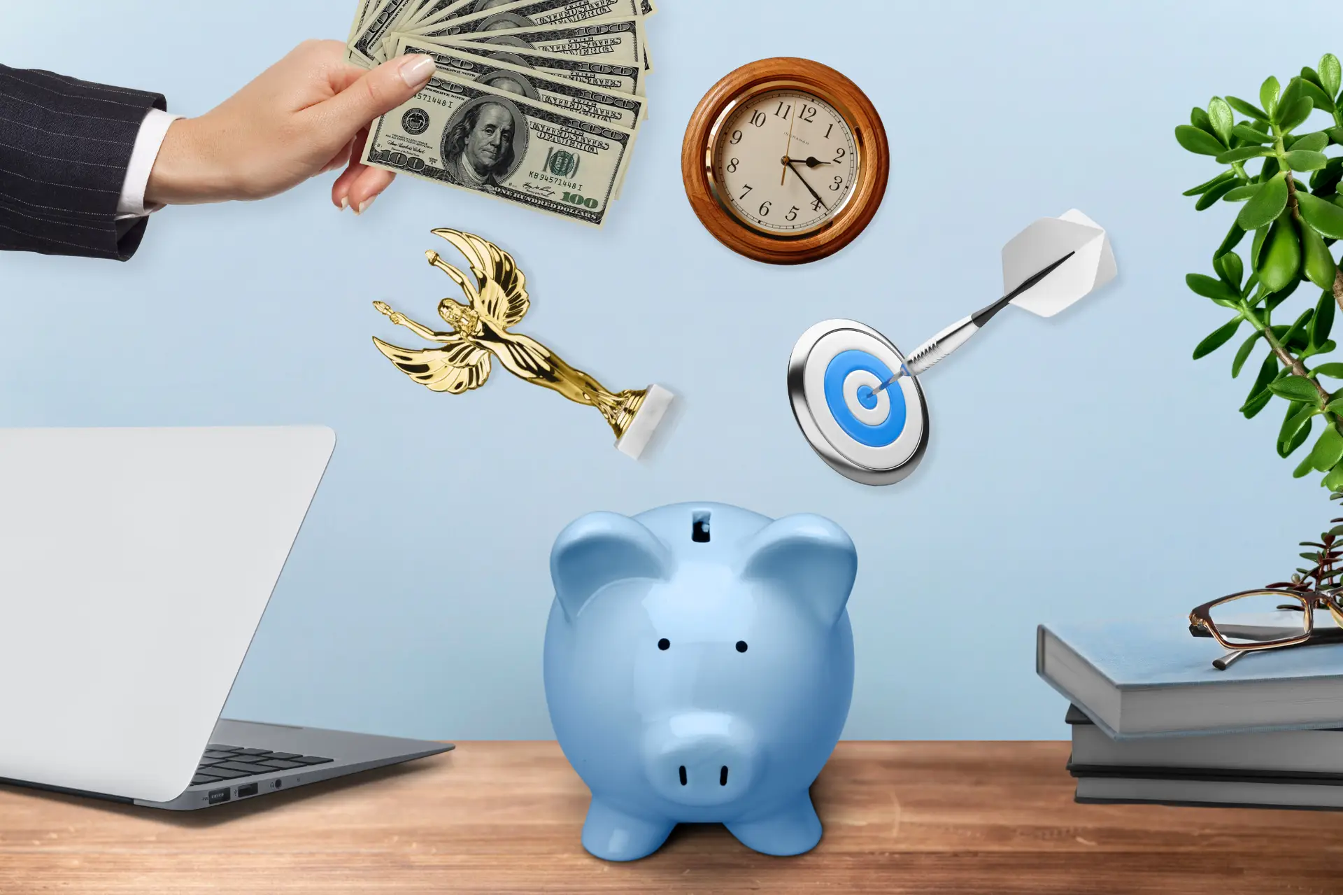 a laptop, piggy bank in a desk and a note with floating clock, trophy, dart and a hand handling us dollar